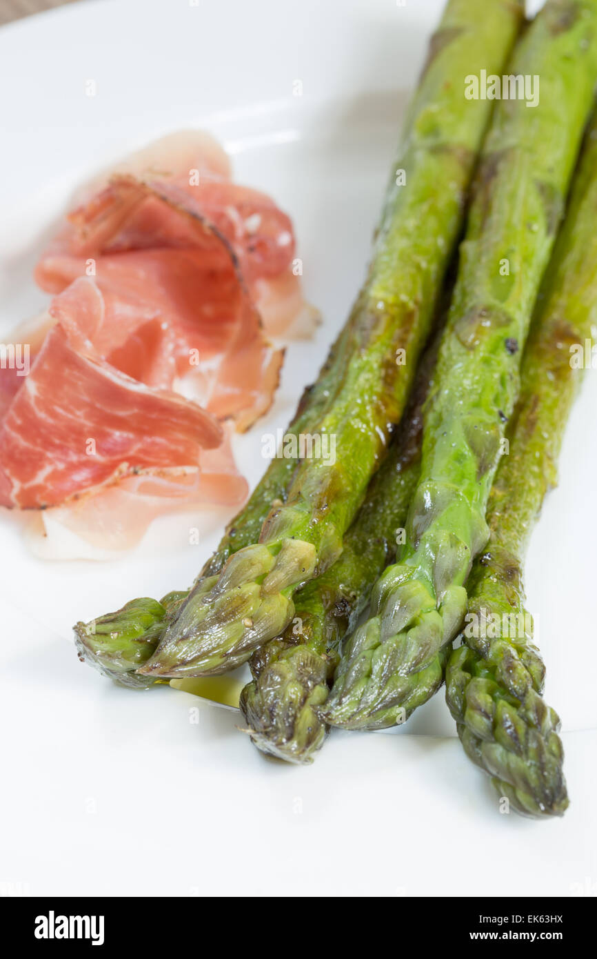 Green asparagus with ham and sauce. Stock Photo