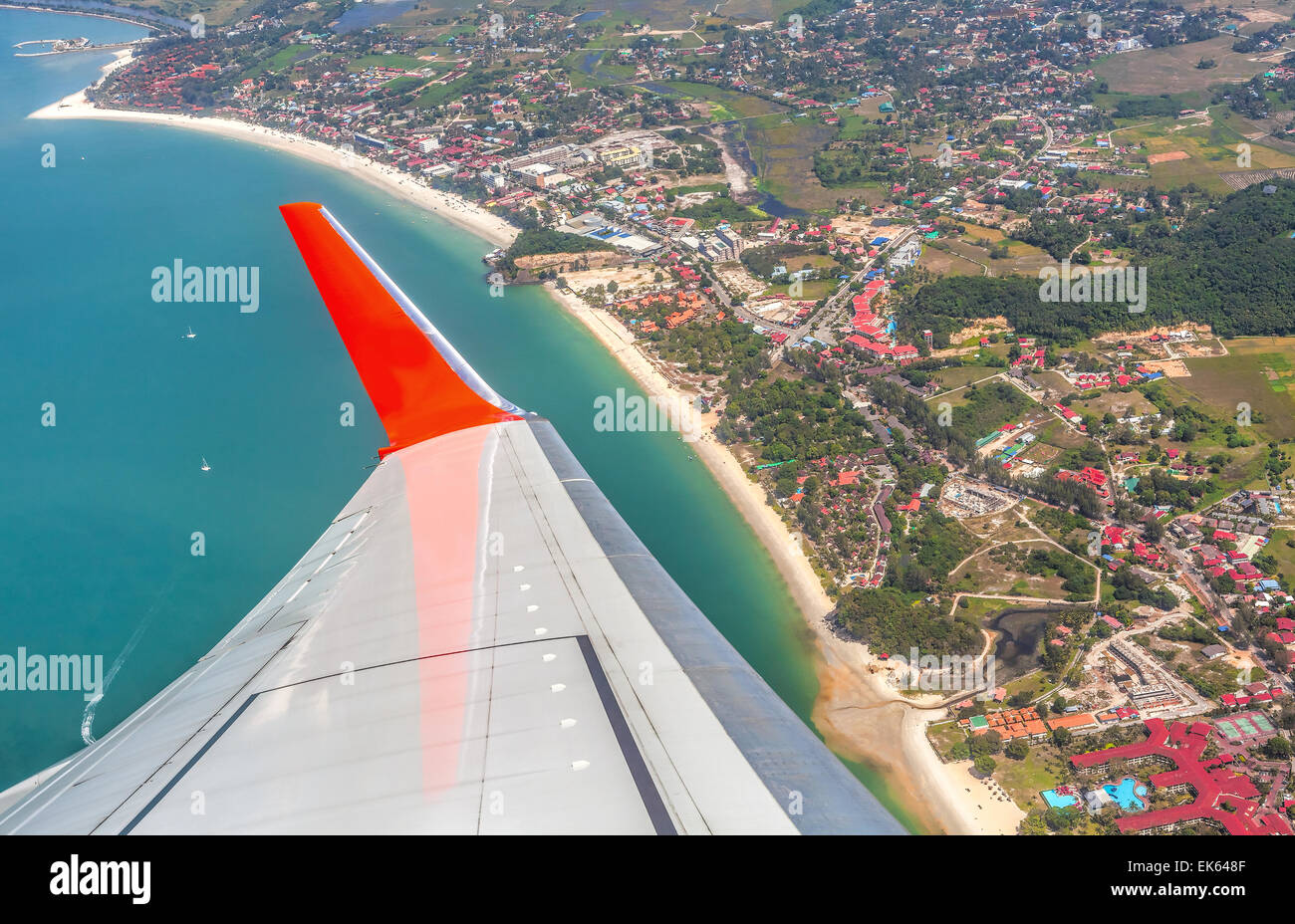 Wing of the plane above Langkawi Island, Malaysia. Stock Photo