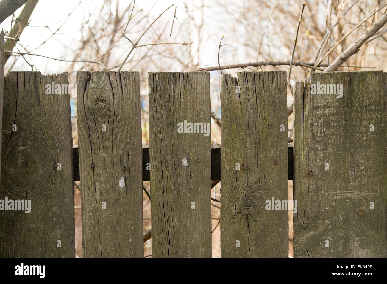 Fragment of old wooden picket fence Stock Photo