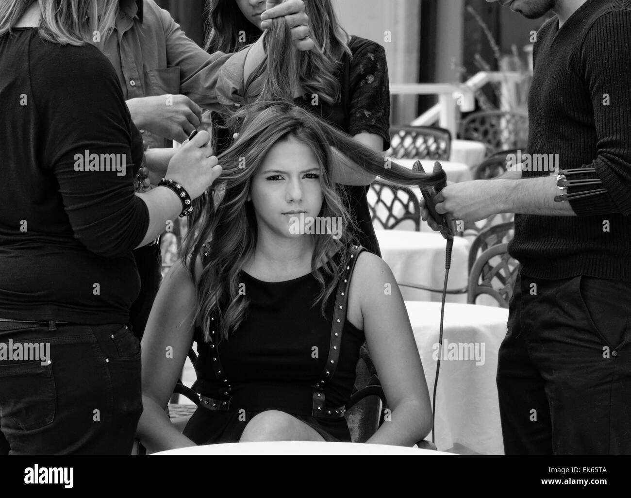 Italy, Sicily, young girl having her hair combed by hairdressers Stock Photo