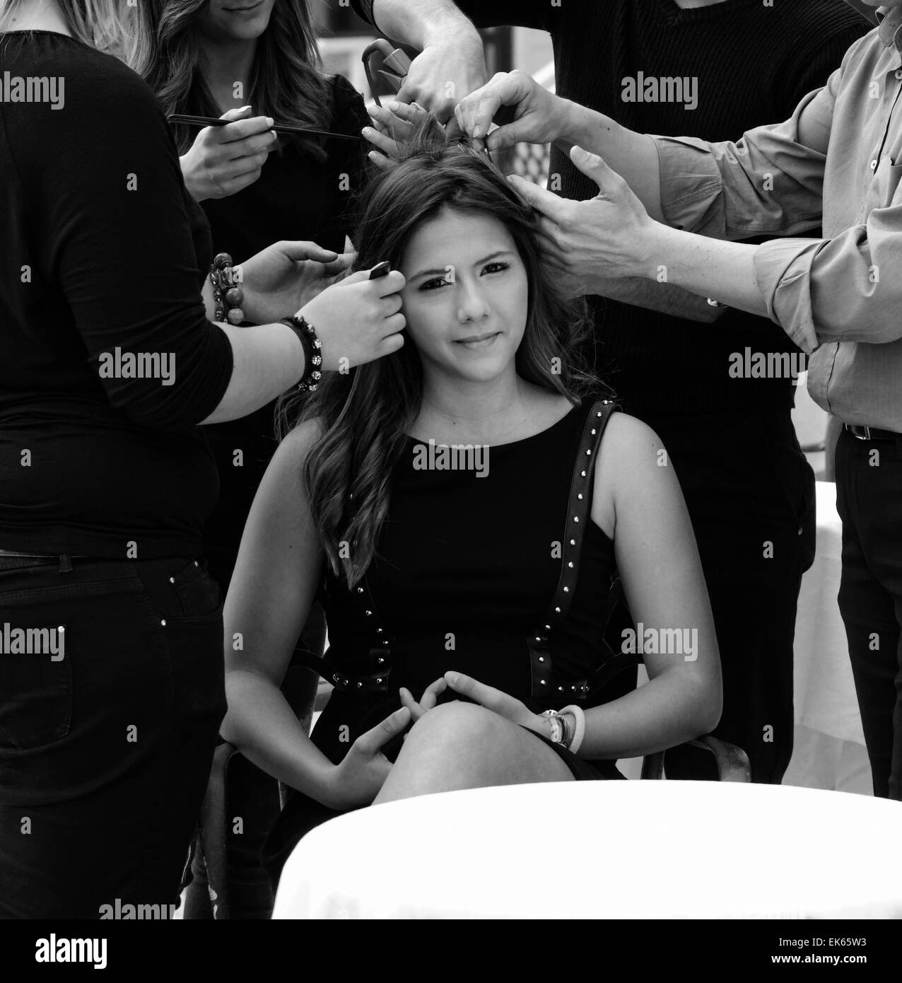 Italy, Sicily, young girl having her hair combed by hairdressers Stock Photo