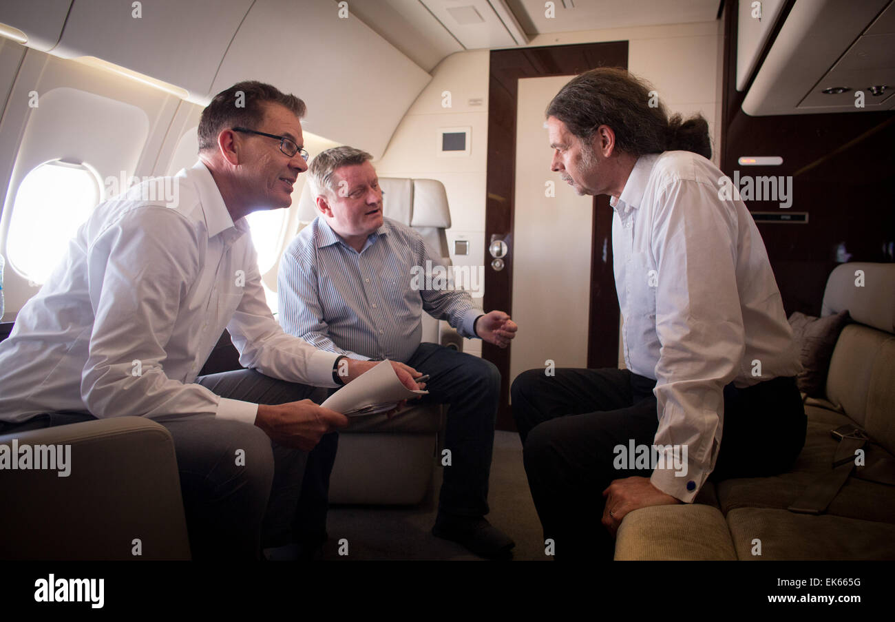 German Minister of Health Hermann Groehe (C), Minister of Development Gerd Mueller (L), and government special commissioner for the Ebola Crisis, Walter Lindner talk during a flight from Berlin to Accra in a German air force Airbus A319 above Tunisia, 07 April 2015. Groehe and Mueller are travelling to Ghana and Liberia to discuss reconstruction after the Ebola epidemic. The first stop is Accra, the capital of Ghana. Ghana remained spared from the Ebola epidemic but serves as a logistical support site for the most affected countries of Liberia, Sierra Leone, and Guinea. Photo: KAY NIETFELD/dpa Stock Photo