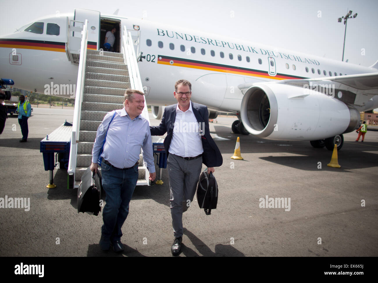 German Minister of Health Hermann Groehe (L) and Minister of Development Gerd Mueller (R) arrive to Kotoka Airport in Accra, Ghana, 07 April 2015. Groehe and Mueller are travelling to Ghana and Liberia to discuss reconstruction after the Ebola epidemic. The first stop is Accra, the capital of Ghana. Ghana remained spared from the Ebola epidemic but serves as a logistical support site for the most affected countries of Liberia, Sierra Leone, and Guinea, . Photo: KAY NIETFELD/dpa Stock Photo
