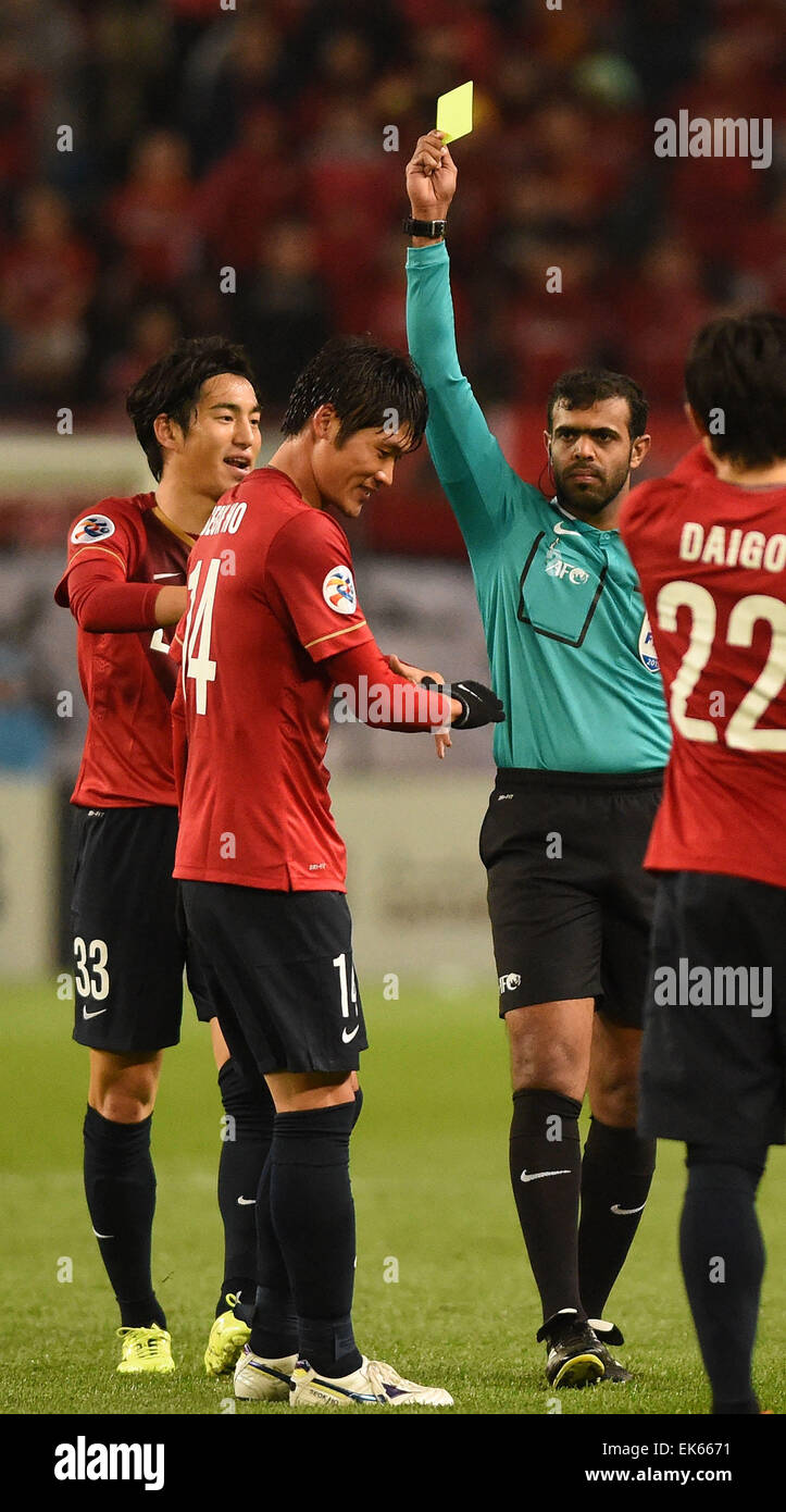 Ibaraki, Japan. 7th Apr, 2015. Hwang Seok-Ho (2nd L) of Japan's Kashima Antlers gets the yellow card during the group H match against China's Guangzhou Evergrande at the 2015 AFC Champions League in Ibaraki, Japan, April 7, 2015. Japan's Kashima Antlers won 2-1. Credit:  Liu Dawei/Xinhua/Alamy Live News Stock Photo