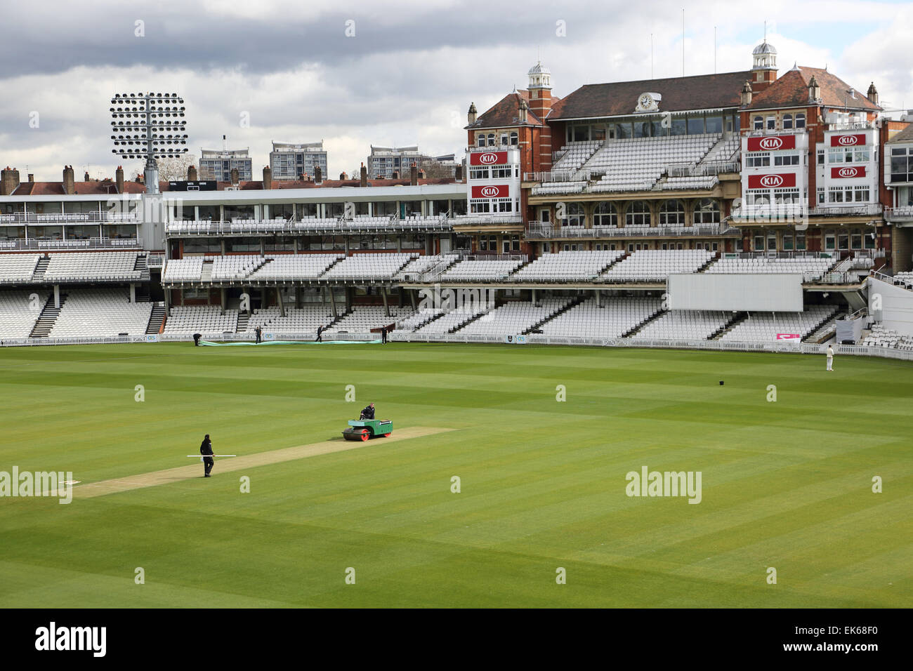 Ground staff maintain the pitch in front of the main grandstand at the Oval Cricket Ground, home of Surrey County Cricket Club Stock Photo