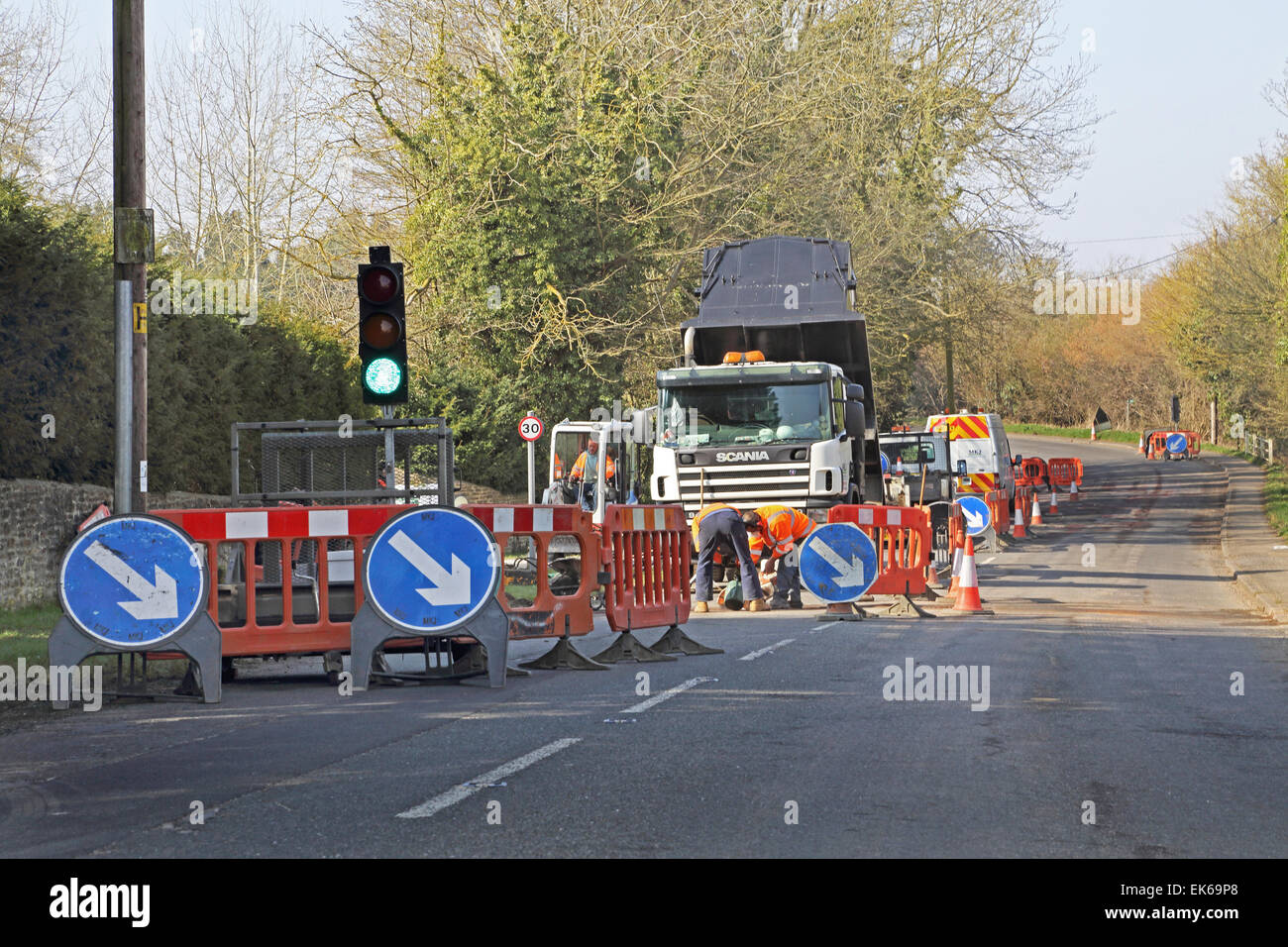 temporary traffic lights during installation of new high speed broadband fibre optic cables in a rural Oxfordshire village Stock Photo