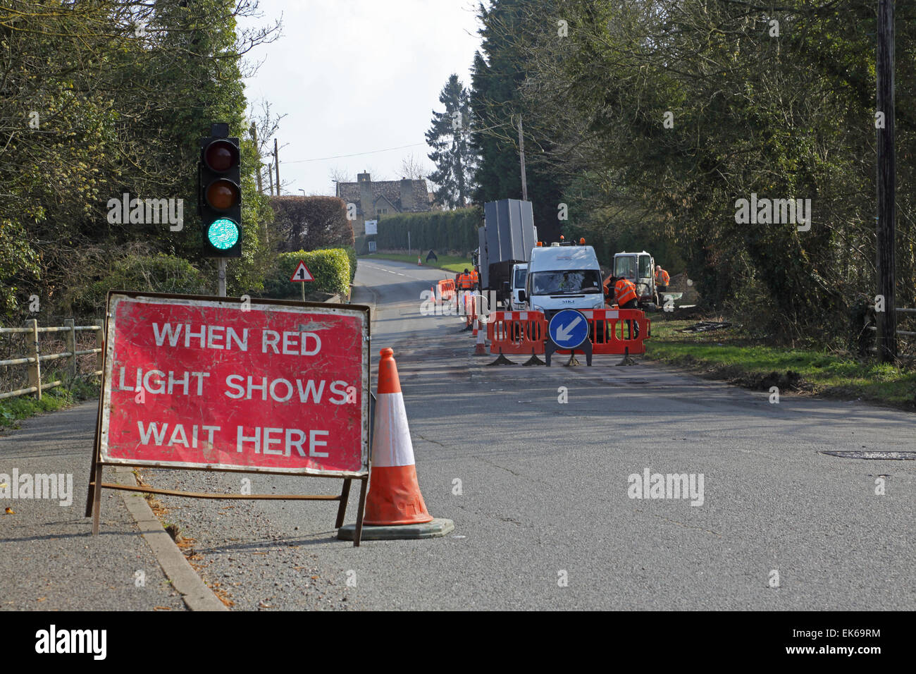 temporary traffic lights during installation of new high speed broadband fibre optic cables in a rural Oxfordshire village Stock Photo