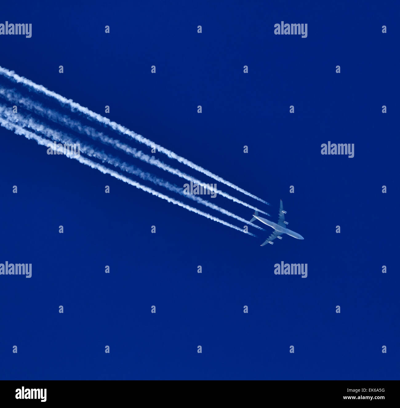 Airplane flying in the blue sky Stock Photo - Alamy