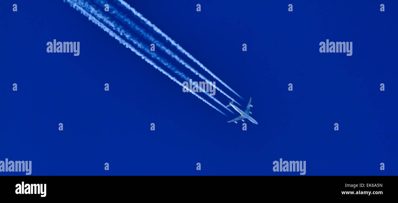 Airplane flying in the blue sky Stock Photo - Alamy