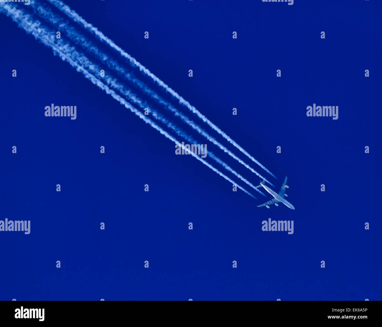 Airplane flying in the blue sky Stock Photo - Alamy