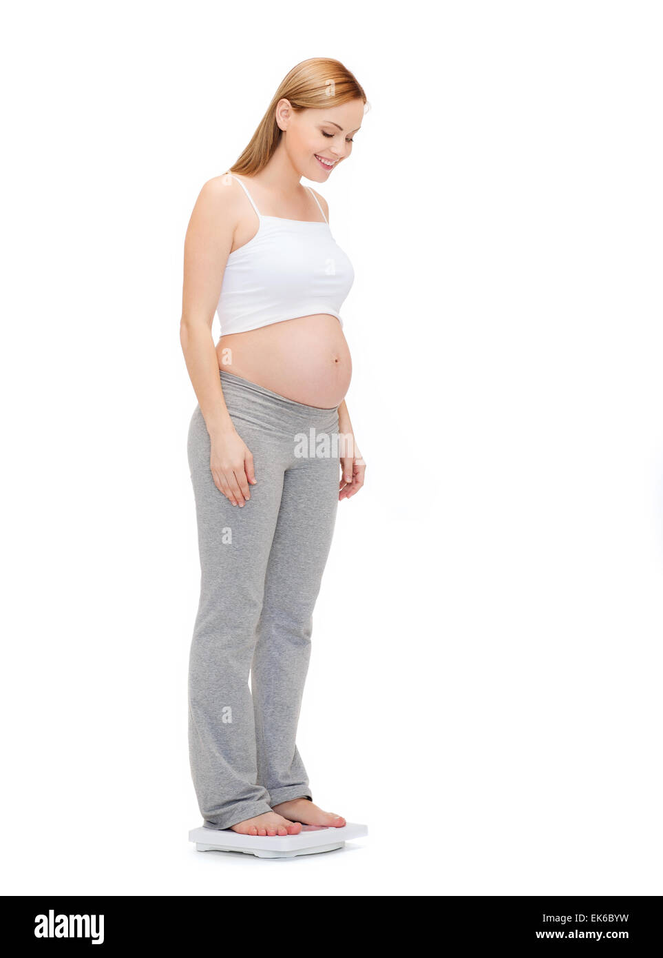 happy pregnant woman weighting herself Stock Photo