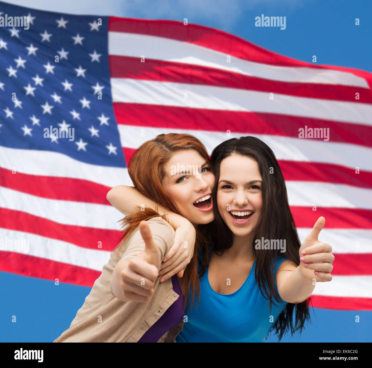 two smiling girls showing thumbs up Stock Photo - Alamy
