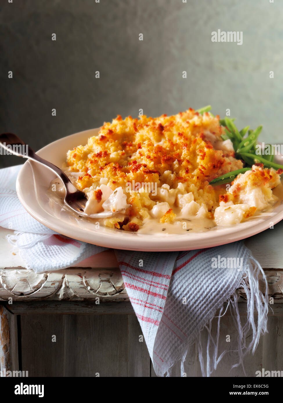 Traditional fish potato pie meal served on a plate in a rustic table setting Stock Photo