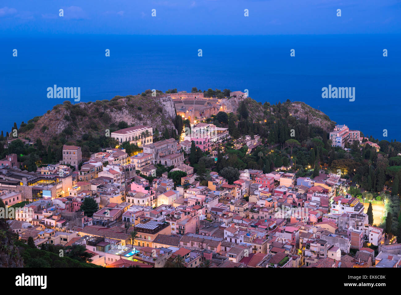 Taormina cityscape, view at night of the historic hill-top city of Taormina with the ancient Greek theatre illuminated (centre), Sicily. Stock Photo