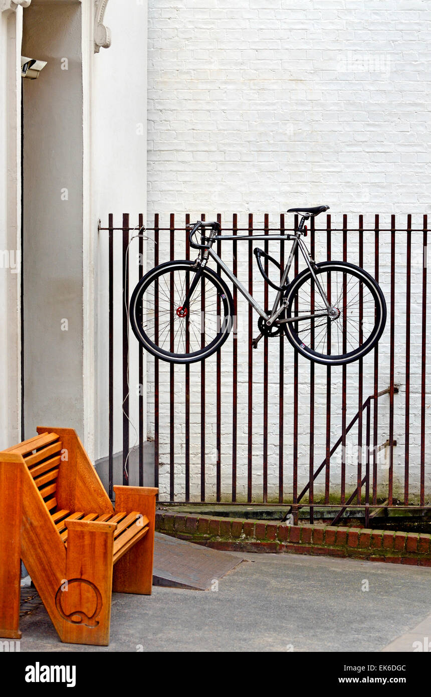 London, England, UK. Bicycle hanging up on railings near Foubert's Place Stock Photo
