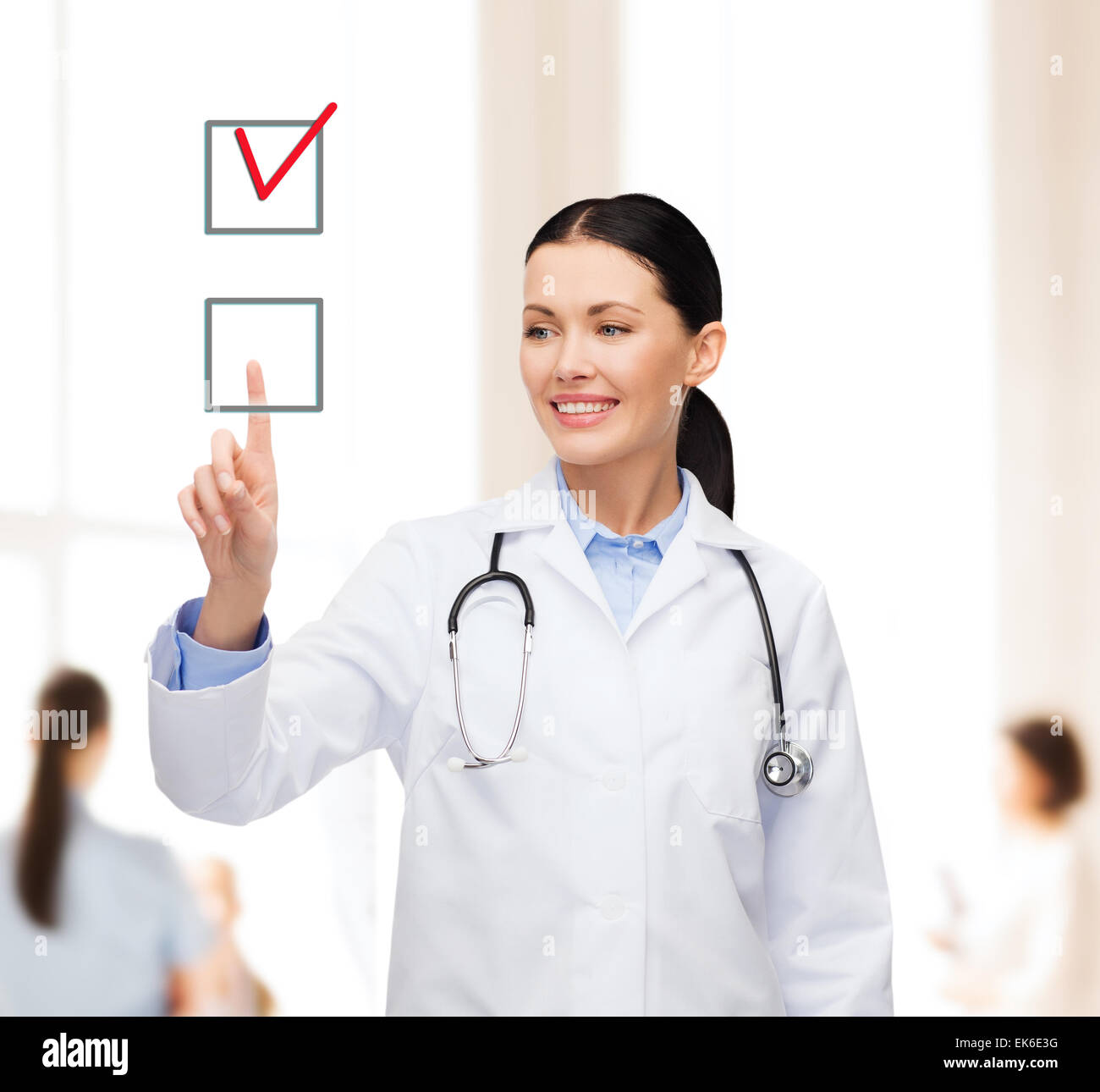 smiling female doctor pointing checkbox Stock Photo - Alamy