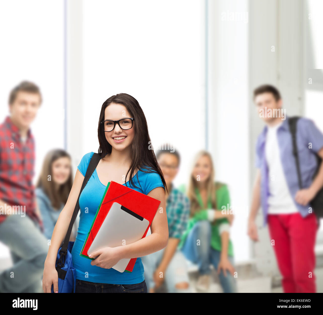 smiling student with bag, folders and tablet pc Stock Photo - Alamy