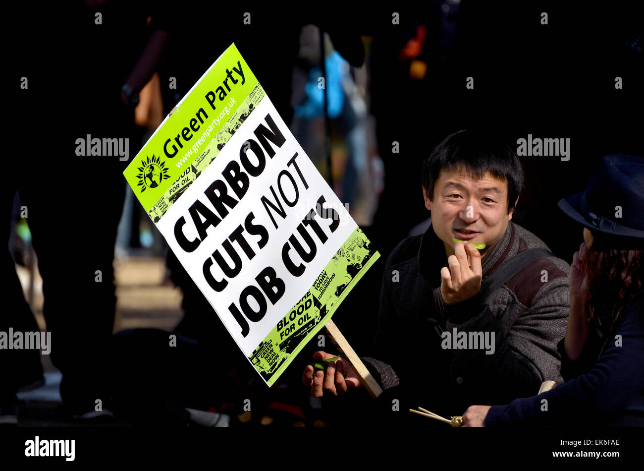 London, 7th March. Time To Act climate march through London to Parliament for a rally. Asian man holding Green Party placard Stock Photo