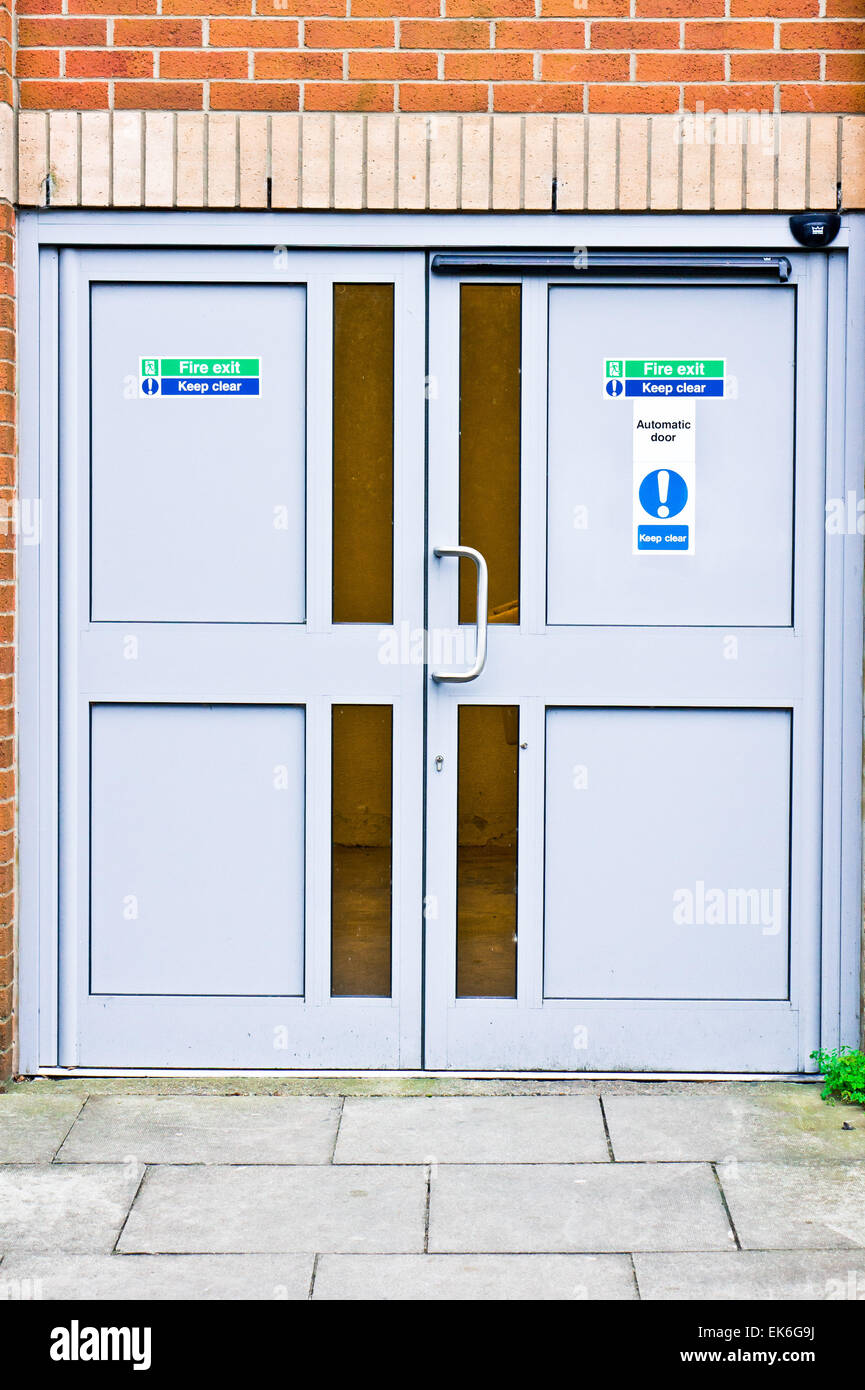 Double fire exit doors in a public building in the UK Stock Photo