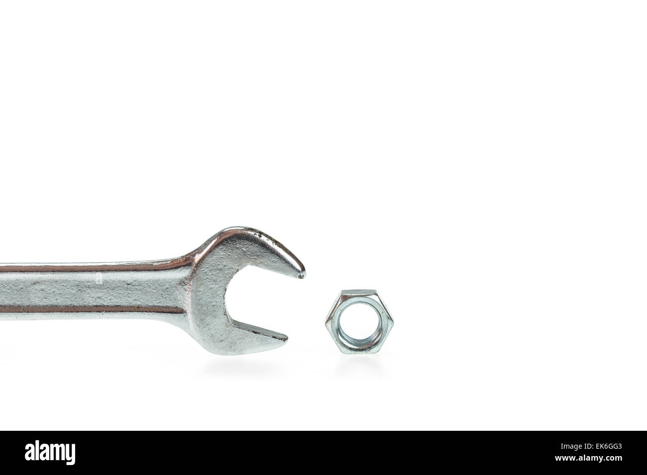 Wrench with nut isolated on white background Stock Photo - Alamy