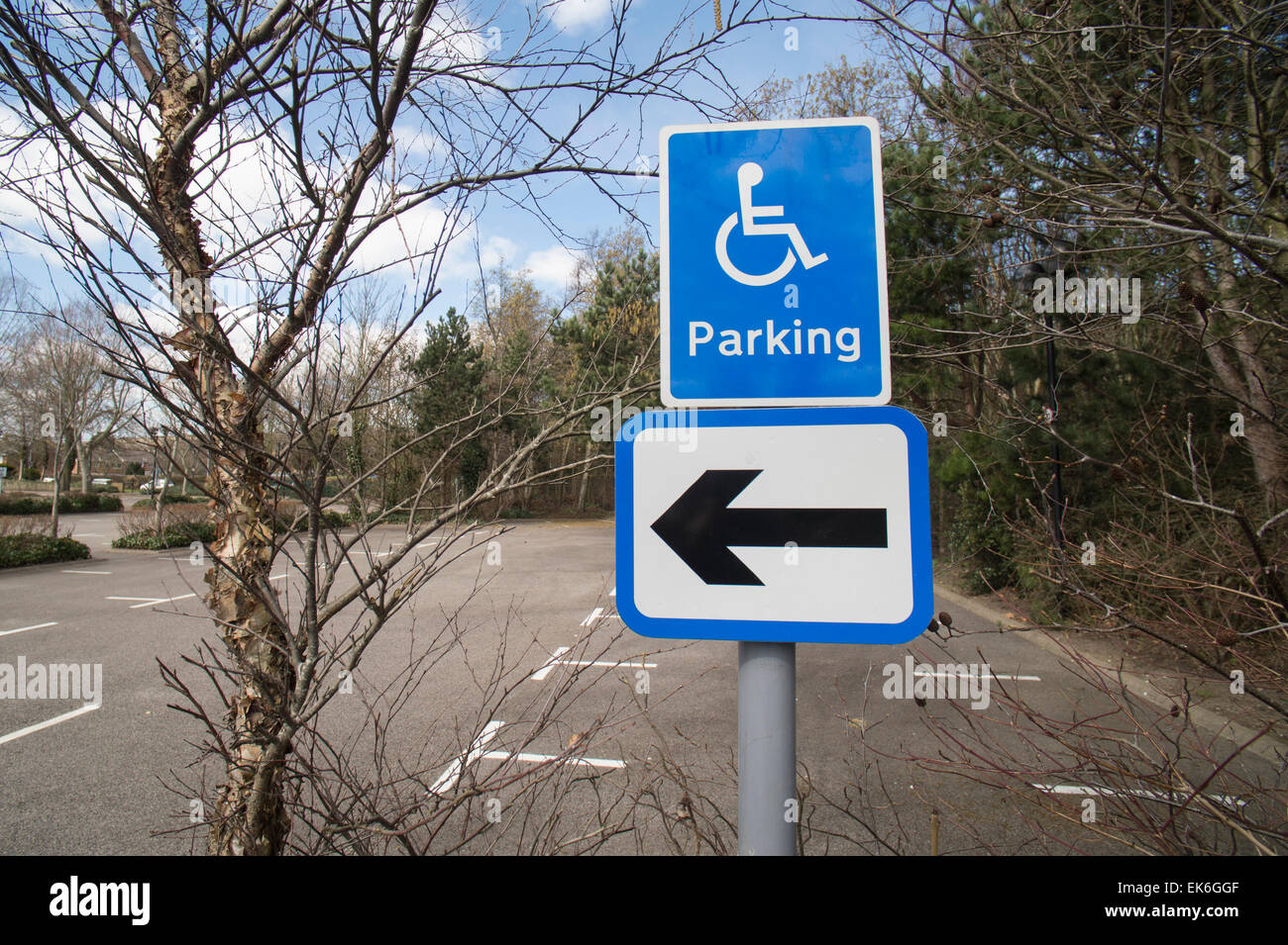 Disabled parking sign and arrow in an empty car park Stock Photo