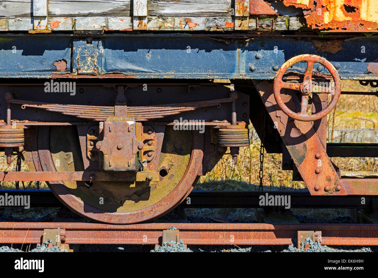 Rusting wheel and suspension on a disused ad abandoned railway carriage, Ayrshire, Scotland, UK Stock Photo
