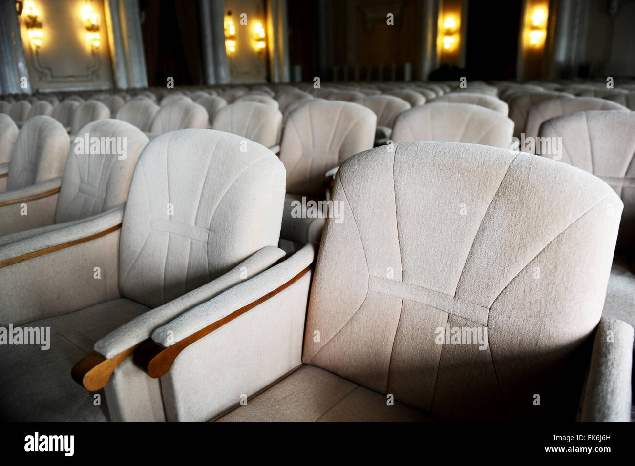 Rows with lots of empty beige velvet armchairs in a big conference room Stock Photo