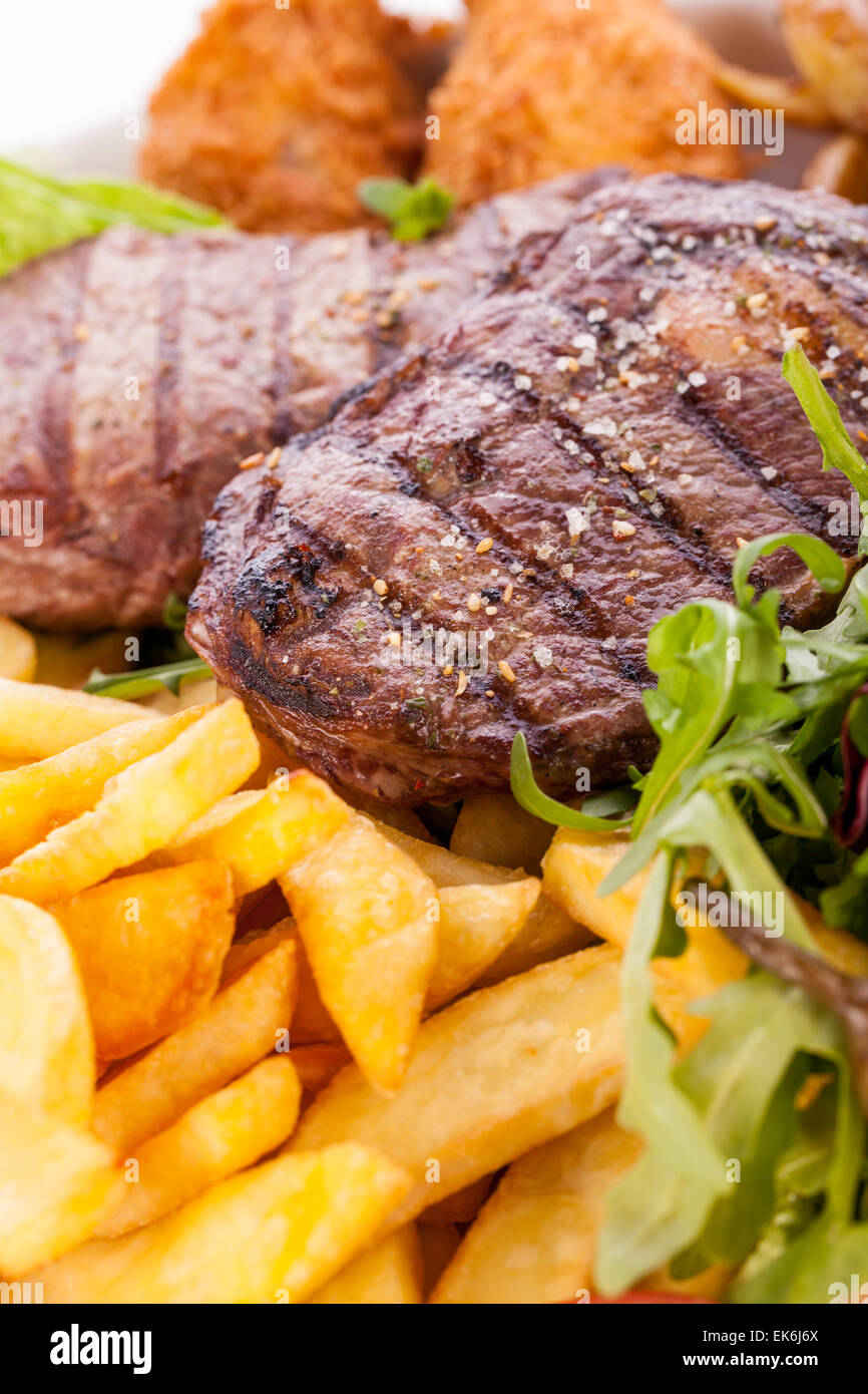Wholesome platter of mixed meats including grilled steak, crispy