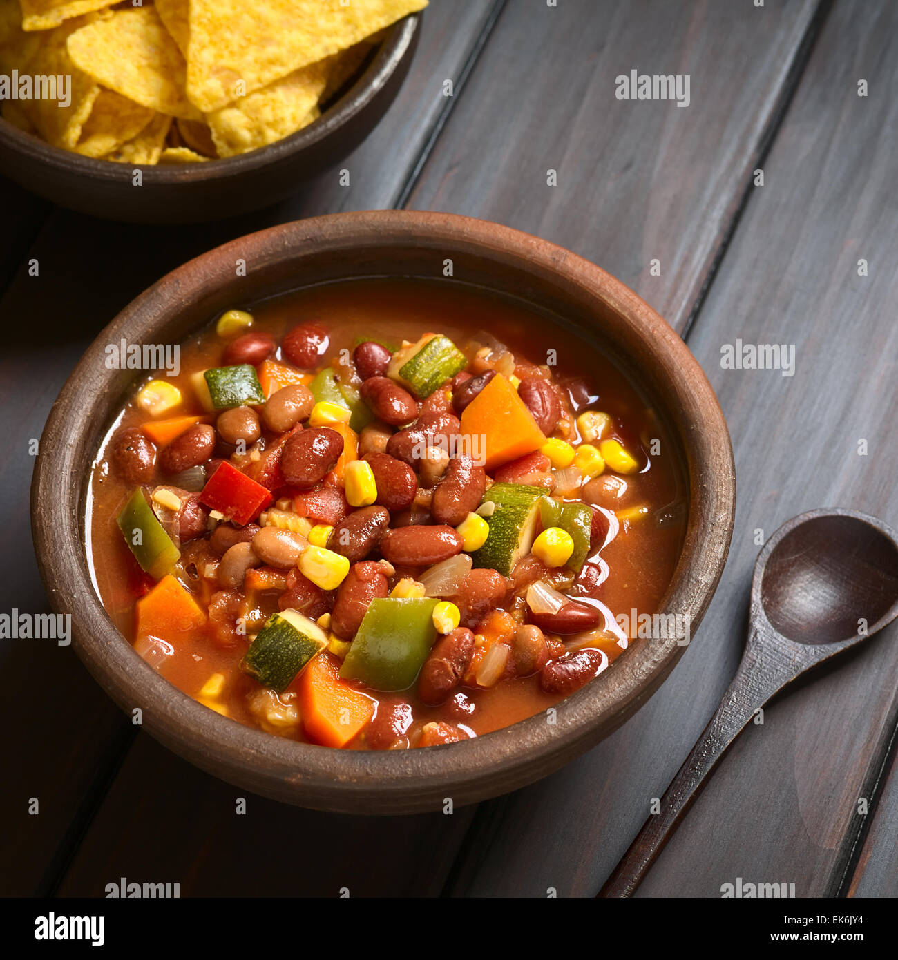 Rustic bowl of vegetarian chili dish made with kidney bean, carrot