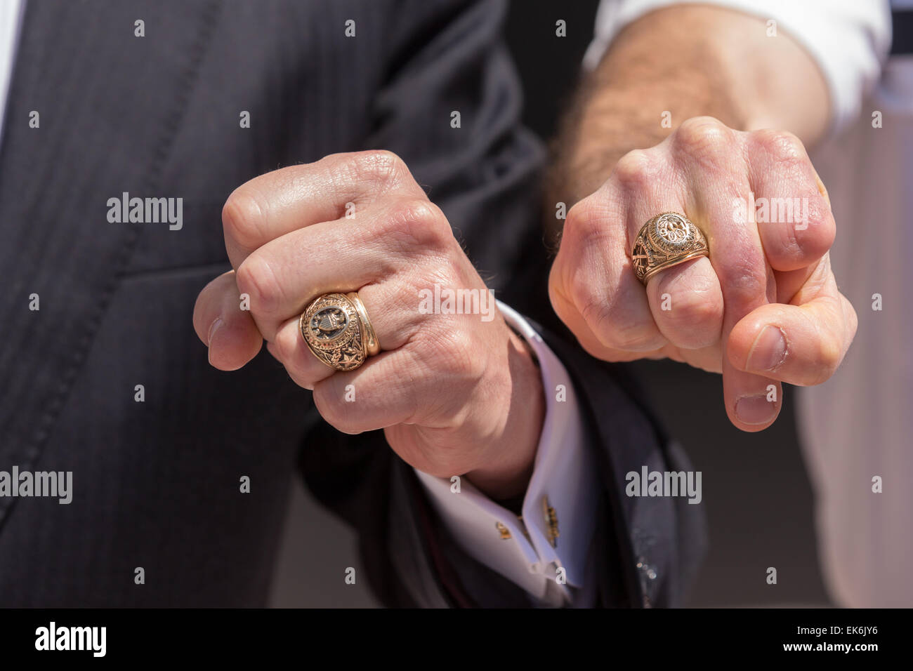 Former Texas Governor and potential Republican presidential candidate Rick Perry compares his Texas A&M class ring to a Citadel class ring during a tour of student barracks on the campus of the Citadel military college April 6, 2015 in Charleston, South Carolina. Stock Photo