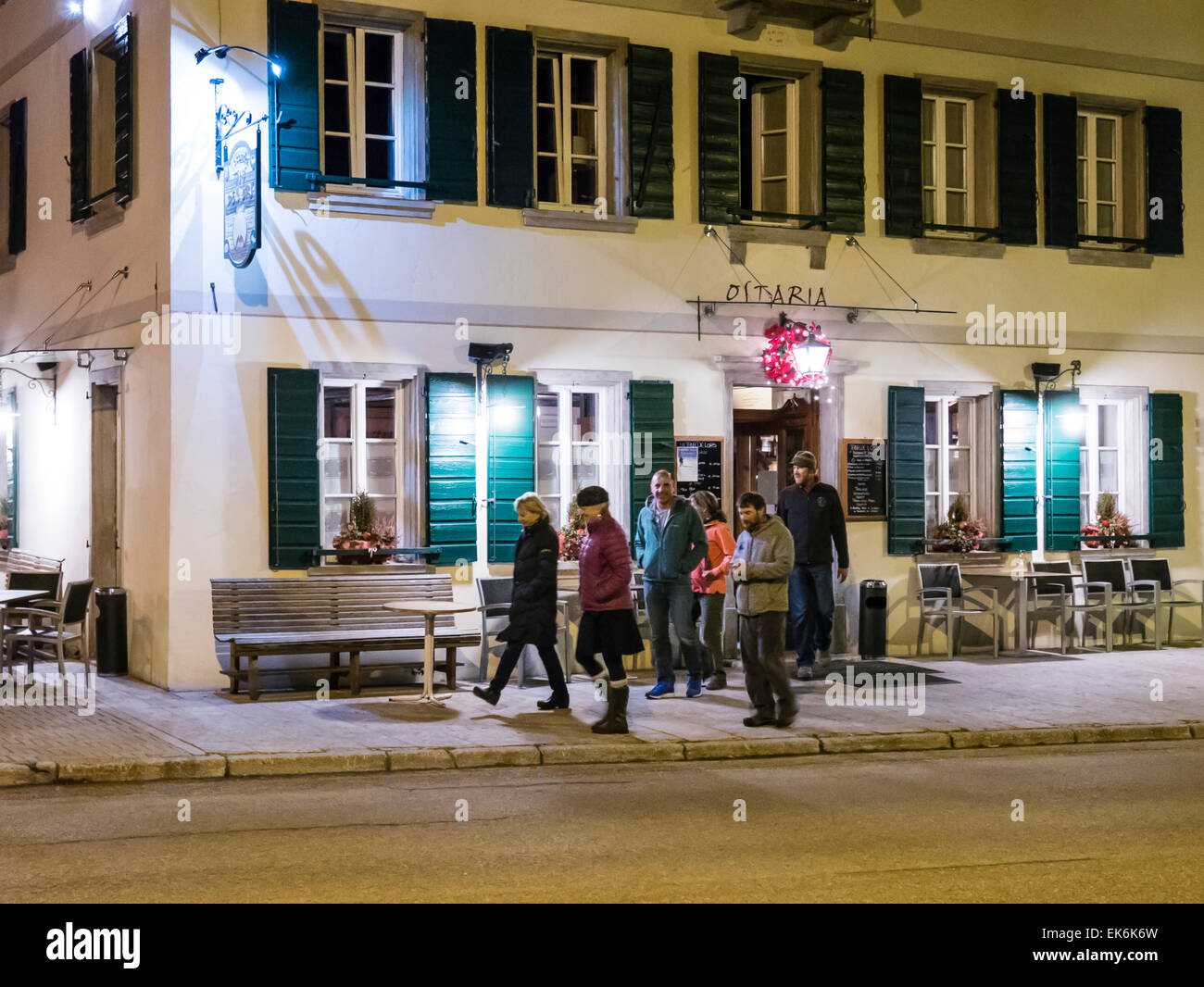 Tourists leaving restaurant in northern Italy Stock Photo