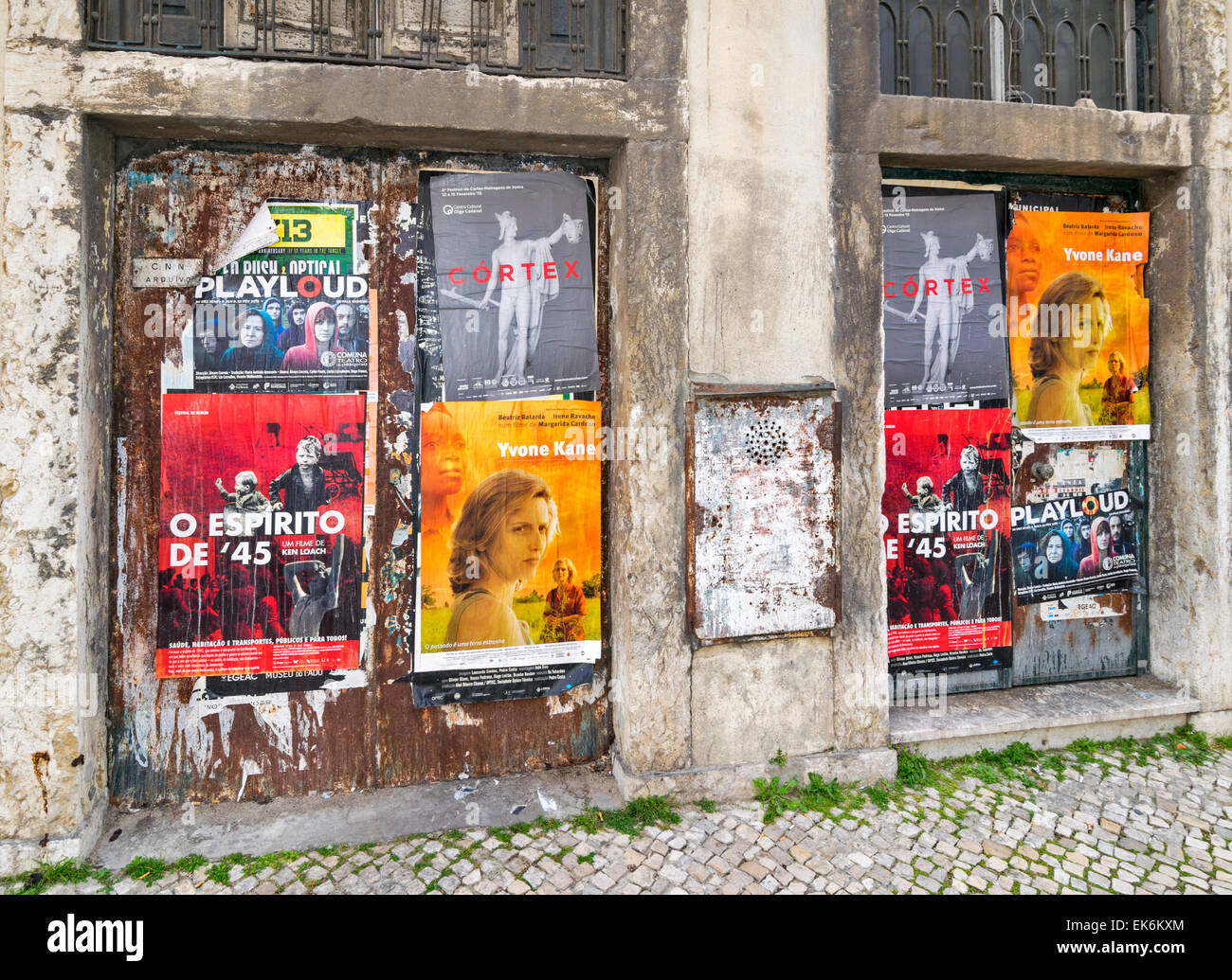 LISBON PORTUGAL FILM POSTERS PASTED ONTO DOORS OF A DERELICT BUILDING Stock Photo