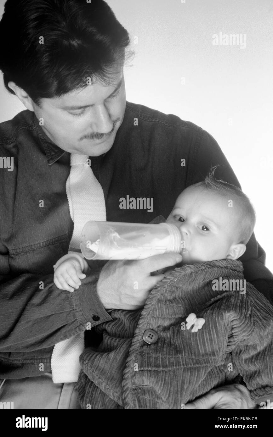 father feeding baby from bottle Stock Photo