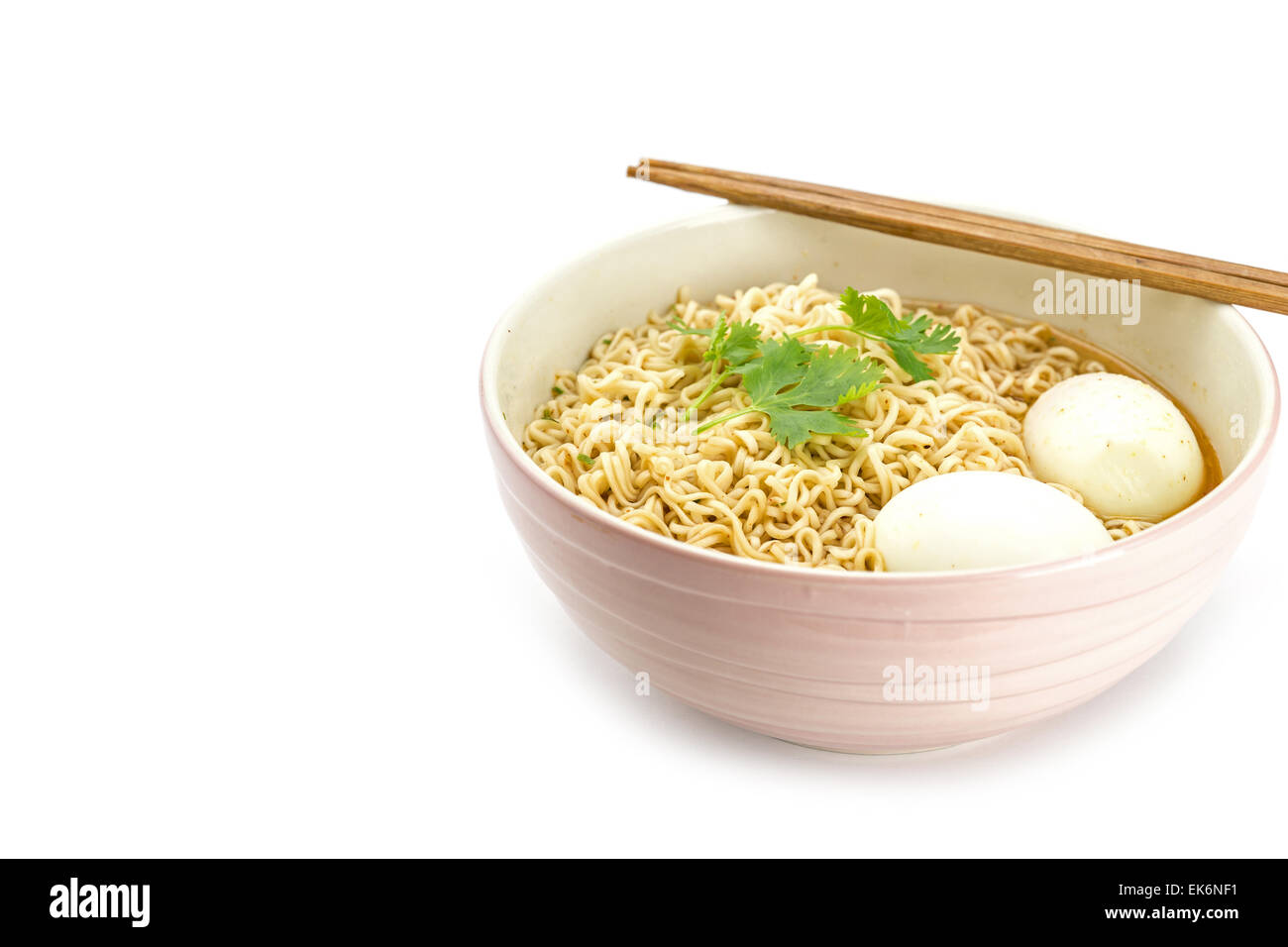 Noodles with boiled eggs in bowl and chopsticks isolated on white background Stock Photo
