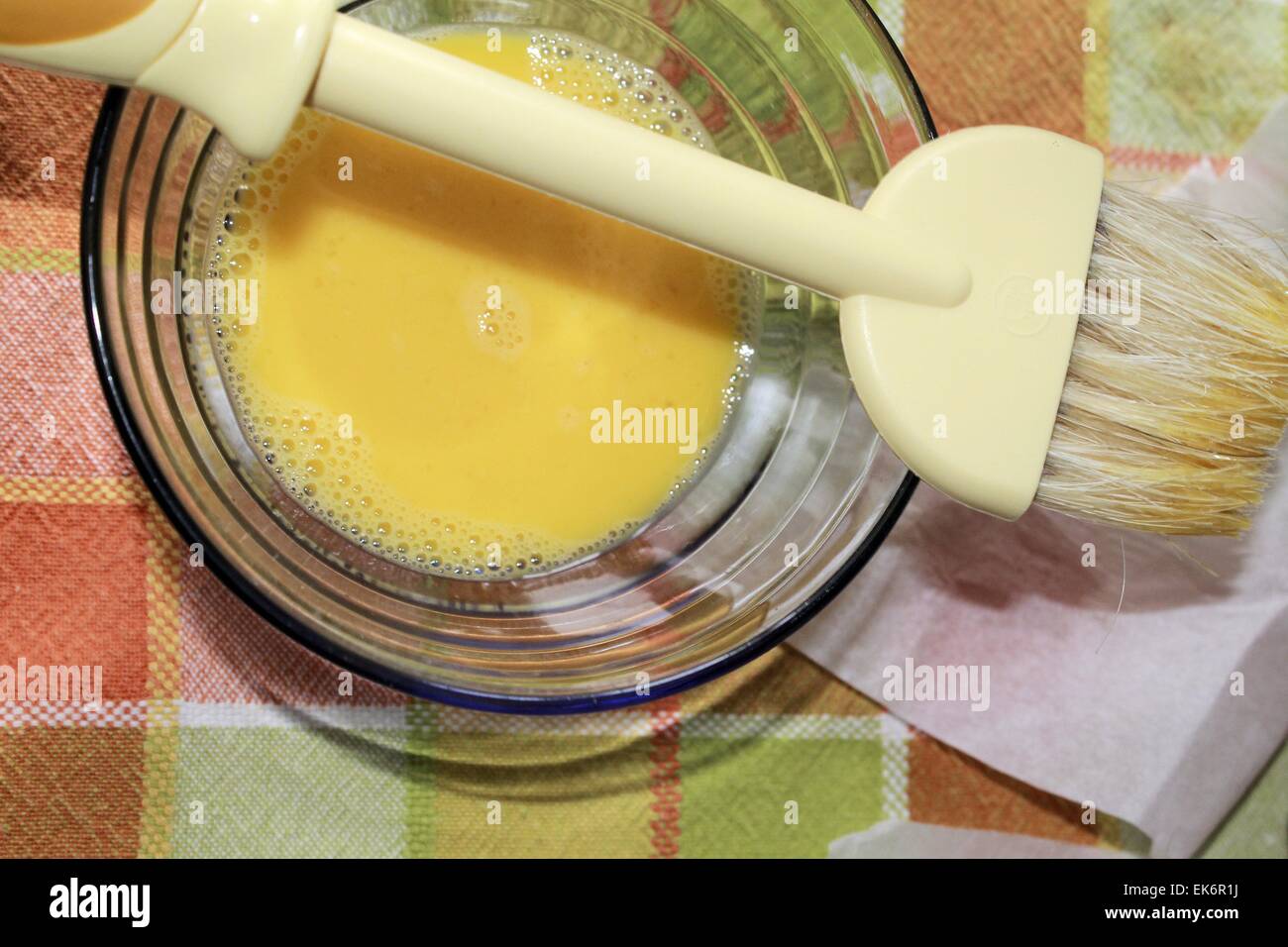 egg yolk in glass bowl and pastry brush Stock Photo Alamy