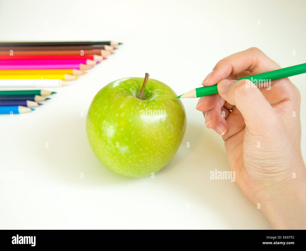 looks like drawing an apple with the colored pencil Stock Photo