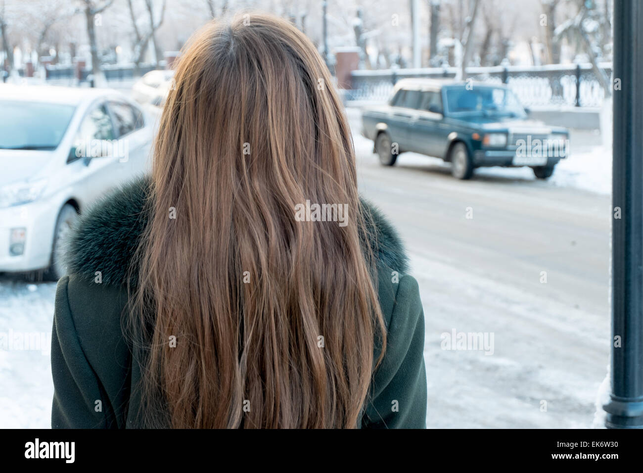 Rear view of a young woman with blond hair in the street Stock Photo ...