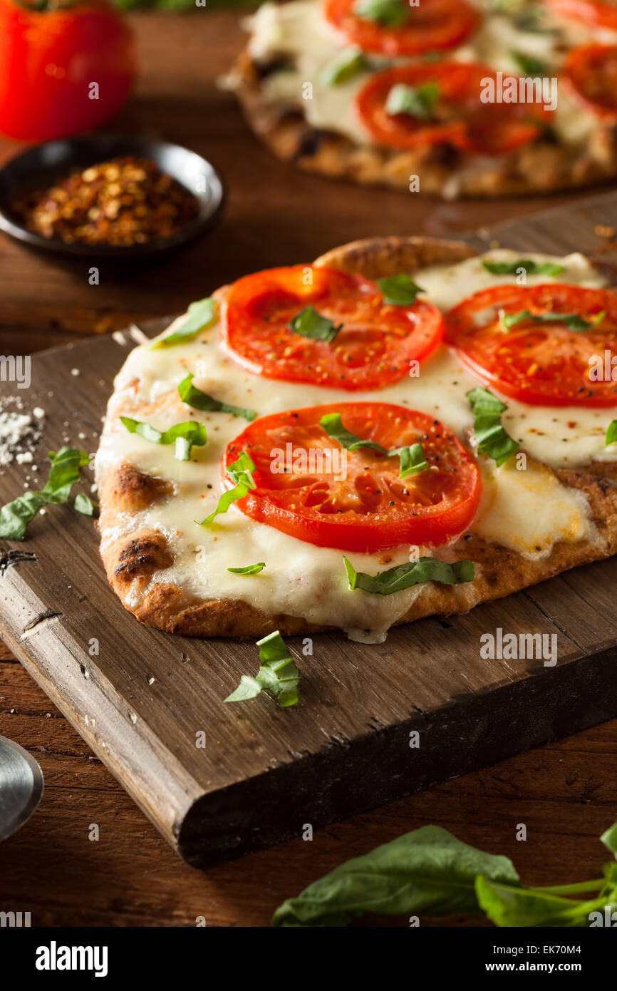 Homemade Margarita Flatbread Pizza with Tomato and Basil Stock Photo