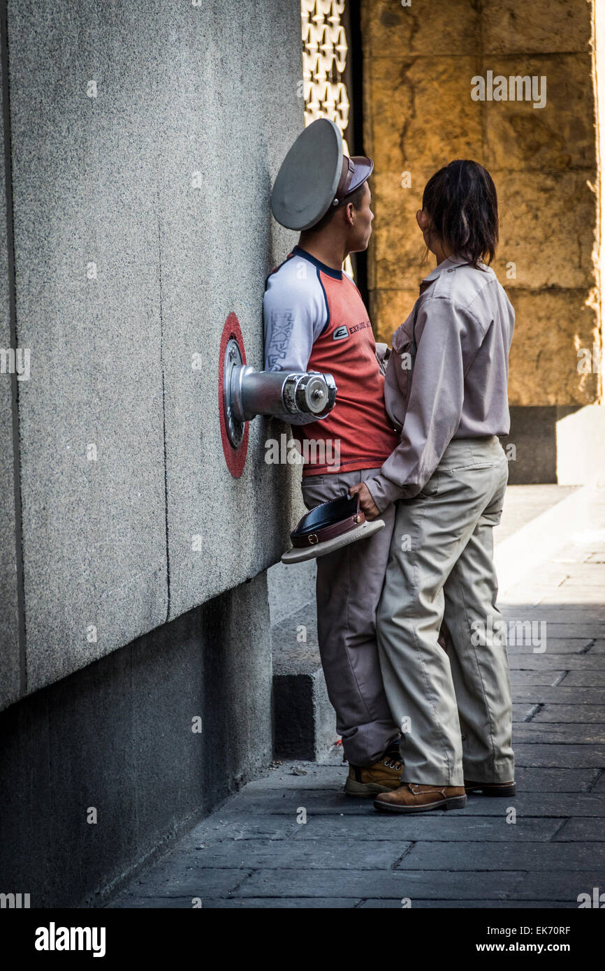 A romantic couple hugging in street musicians 'organillero' uniform in Mexico City Stock Photo