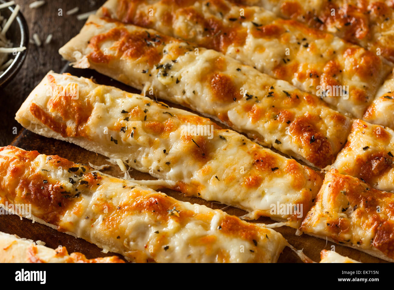 Homemade Cheesy Breadsticks with Marinara Sauce for Dipping Stock Photo