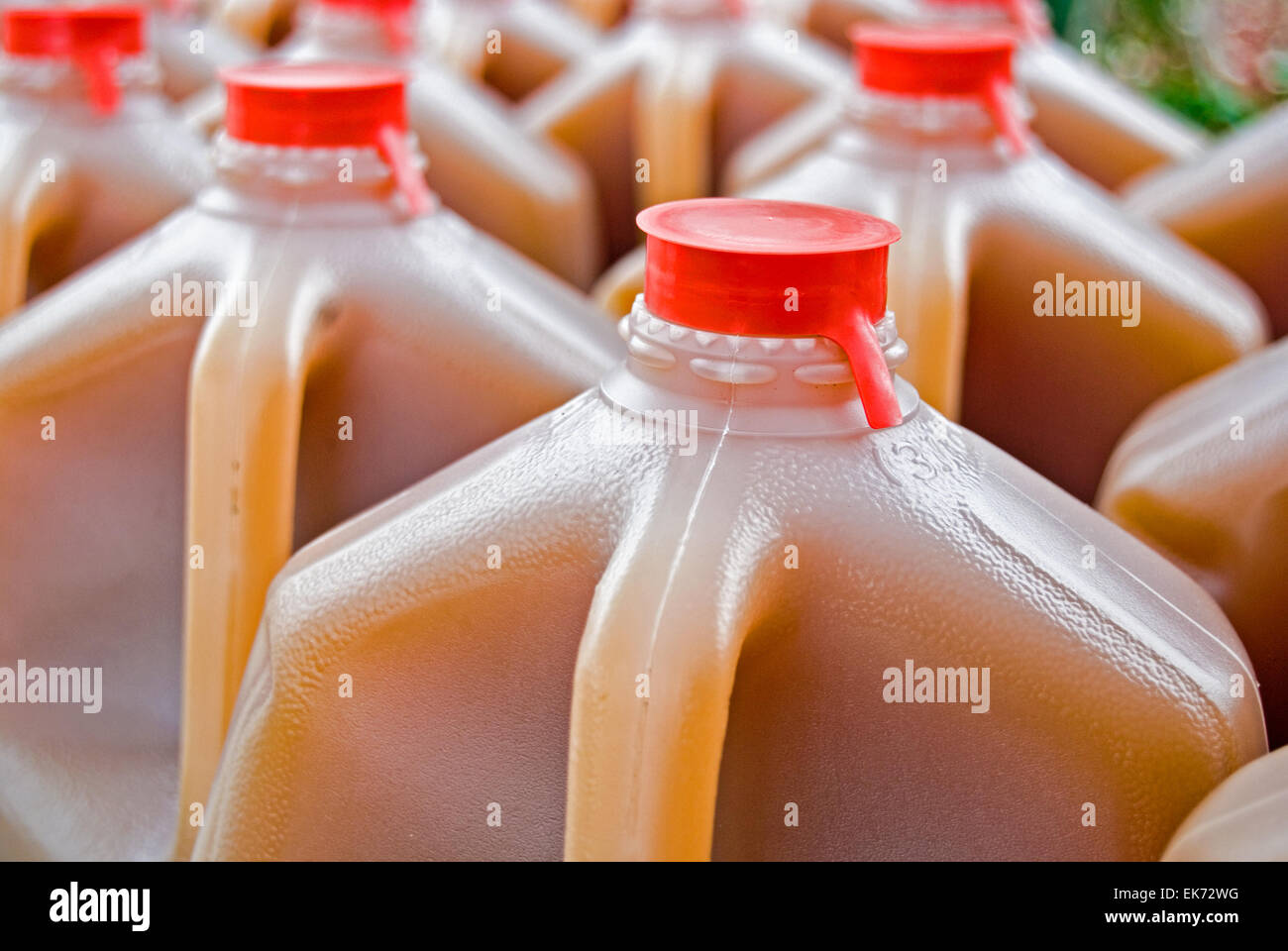 Apple cider in plastic gallon jugs at the market Stock Photo Alamy