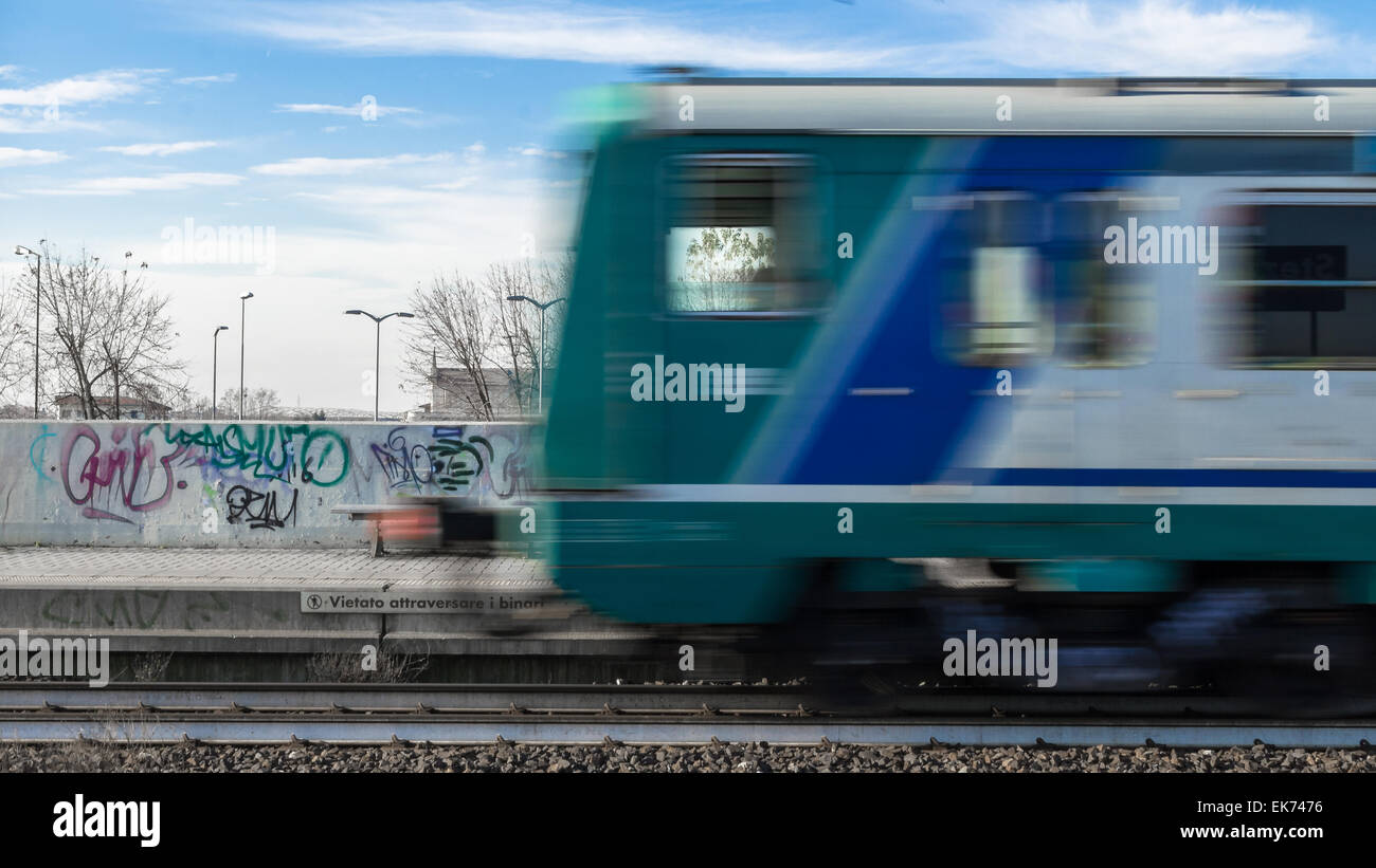 A train runs without stopping at the station. Stock Photo