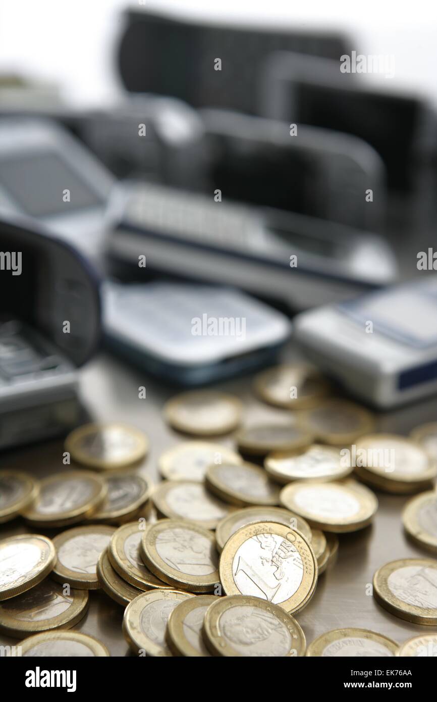 Assorted mixed mobile phones with lots of euro coin Stock Photo