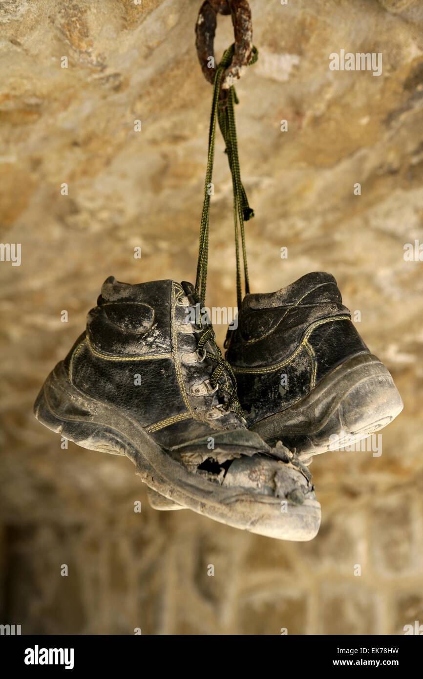 Construction worker left his aged old boots away Stock Photo