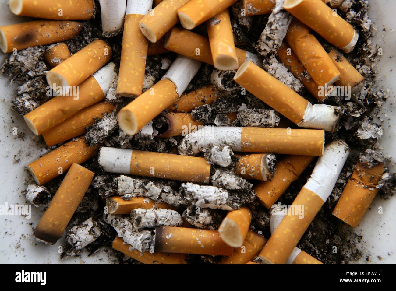 Ashtray full of cigarettes. Dirty tobacco texture Stock Photo