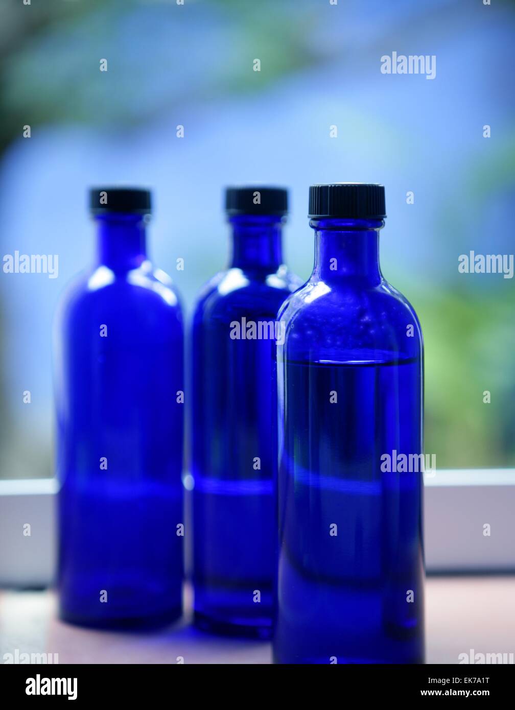 Three Blue glass body oil bottles Stock Photo Alamy