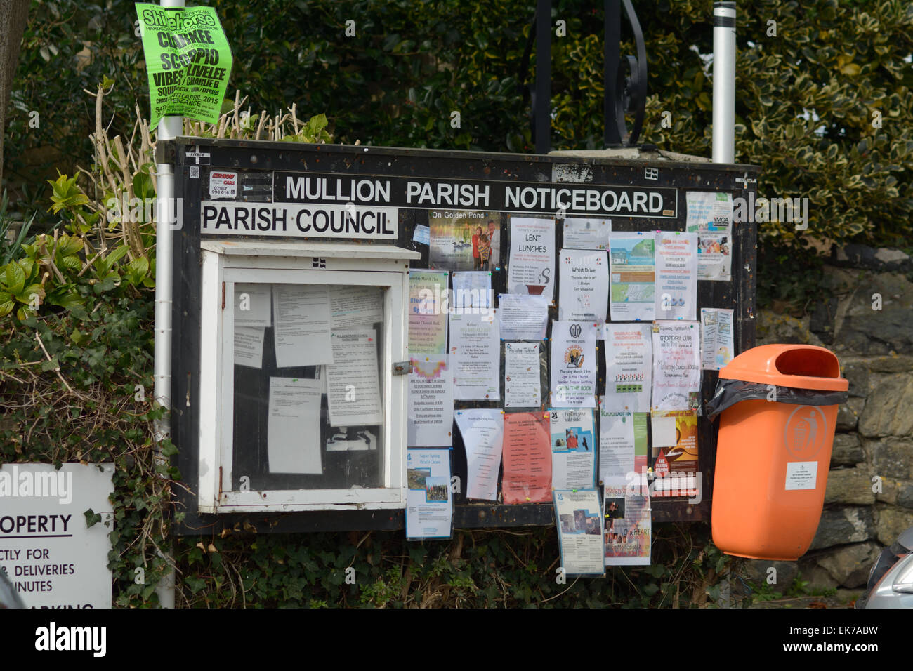 Mullion Parish Council Noticeboard covered in leaflets, Mullion, Cornwall, England Stock Photo