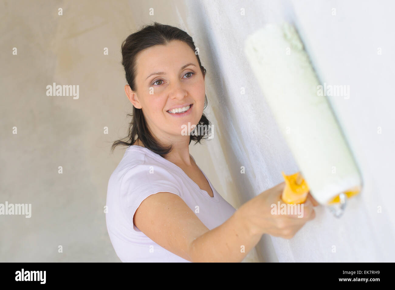 Young Woman Painting A Wall Stock Photo - Alamy