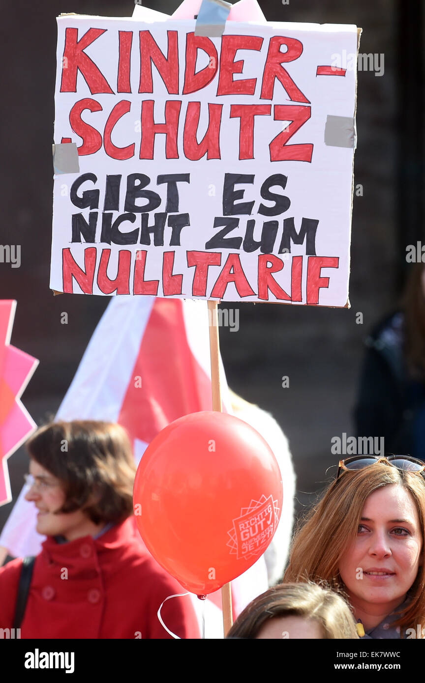 Karlsruhe, Germany. 08th Apr, 2015. Pre-school teachers gather during a warning strike in Karlsruhe, Germany, 08 April 2015, holding a sign that reads 'Kinderschutz gibt es nicht zum Nulltarif' (Child protection is not for free). German trade unions Verdi and GEW demand adjustments to wage brackets, which would ultimately increase the salaries of childcare assistants, pre-school teachers and social workers currently employed by local social service facilities. Photo: Uli Deck/dpa/Alamy Live News Stock Photo