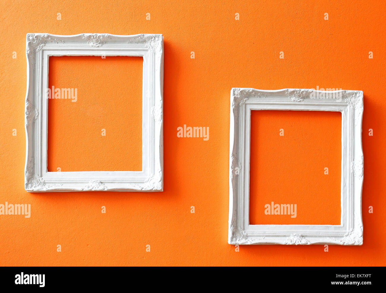 white vintage frames on orange wall Stock Photo